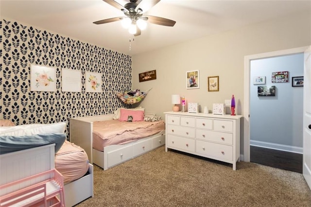 carpeted bedroom with ceiling fan and baseboards