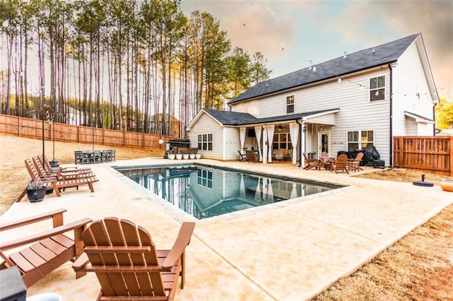 view of swimming pool featuring a patio area, a fenced backyard, and a fenced in pool