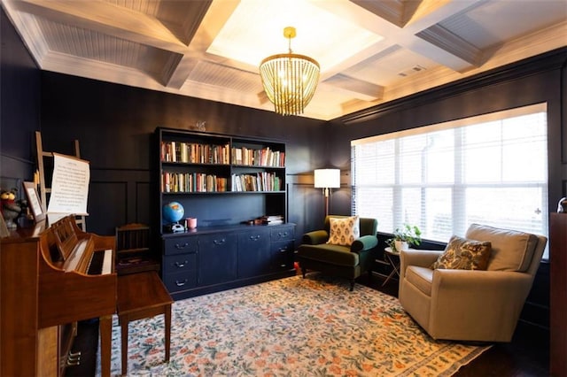 living area with coffered ceiling, beamed ceiling, a decorative wall, and an inviting chandelier