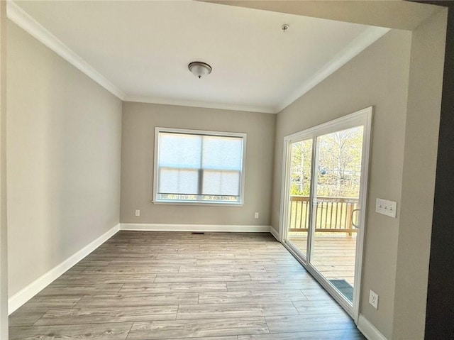 empty room with ornamental molding and light wood-type flooring