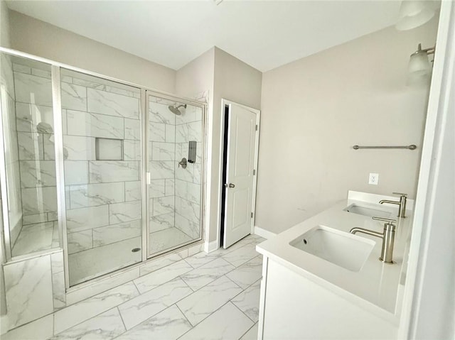 bathroom featuring a shower with door and vanity