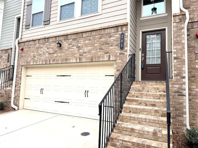 doorway to property with a garage