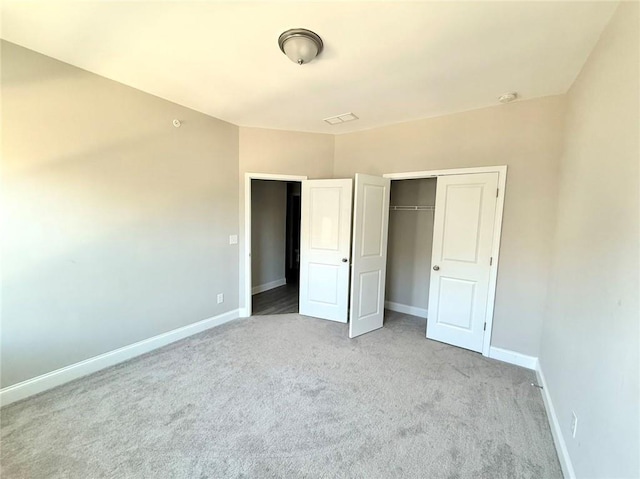 unfurnished bedroom with a closet and light carpet