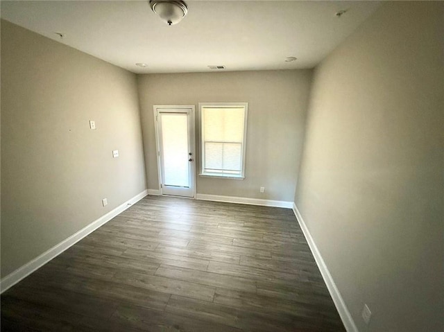 empty room featuring dark wood-type flooring