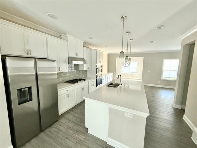 kitchen featuring sink, white cabinetry, appliances with stainless steel finishes, and a kitchen island with sink