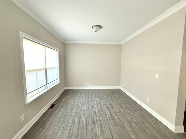 empty room with hardwood / wood-style floors and ornamental molding