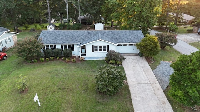 ranch-style home featuring a front lawn and a garage