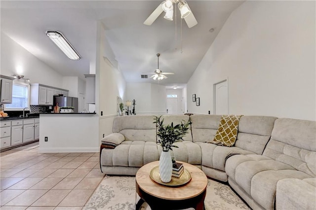 2220 Lily Valley Dr, Lawrenceville, GA 30045 - living area featuring a ceiling fan, light tile patterned floors, and high vaulted ceiling