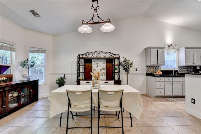 2220 Lily Valley Dr, Lawrenceville, GA 30045 - dining space with light tile patterned floors and vaulted ceiling