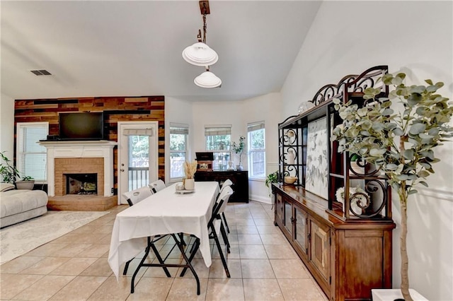 2220 Lily Valley Dr, Lawrenceville, GA 30045 - dining area featuring light tile patterned flooring and a brick fireplace
