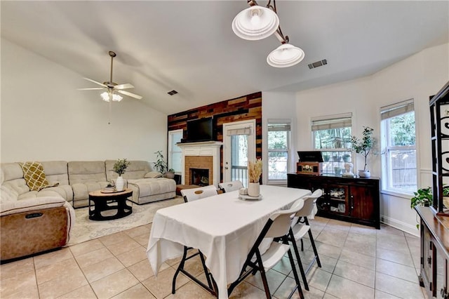 2220 Lily Valley Dr, Lawrenceville, GA 30045 - dining room with light tile patterned floors, vaulted ceiling, a fireplace, and ceiling fan