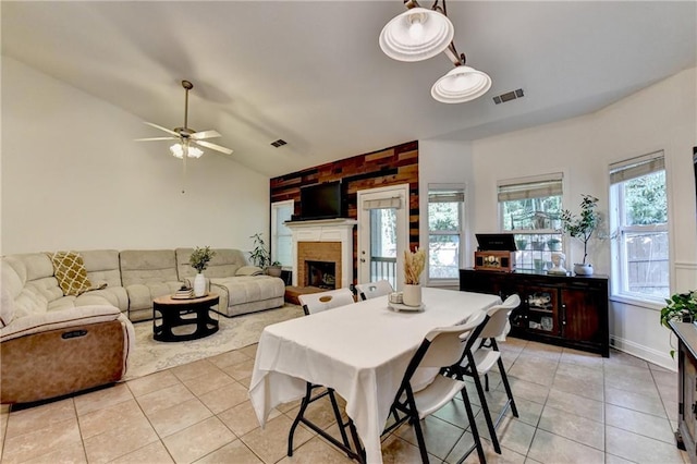2220 Lily Valley Dr, Lawrenceville, GA 30045 - dining area featuring vaulted ceiling, light tile patterned floors, a ceiling fan, and a brick fireplace