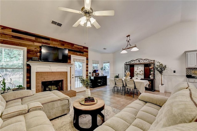 2220 Lily Valley Dr, Lawrenceville, GA 30045 - living area featuring a ceiling fan, light tile patterned floors, a fireplace, wooden walls, and high vaulted ceiling
