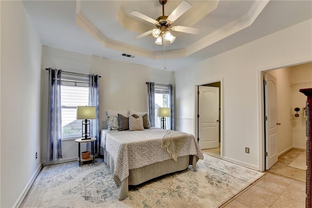 2220 Lily Valley Dr, Lawrenceville, GA 30045 - bedroom with crown molding, a tray ceiling, ceiling fan, and light tile patterned flooring
