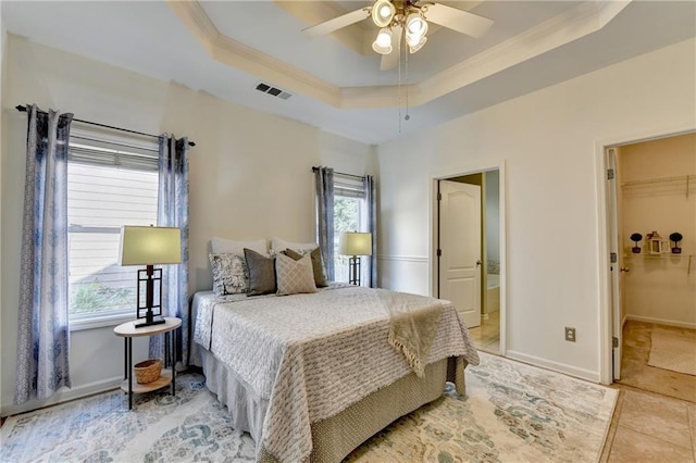 2220 Lily Valley Dr, Lawrenceville, GA 30045 - bedroom featuring crown molding, a tray ceiling, light tile patterned flooring, and a ceiling fan