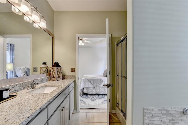 2220 Lily Valley Dr, Lawrenceville, GA 30045 - ensuite bathroom featuring vanity, tile patterned floors, ceiling fan, and a shower stall