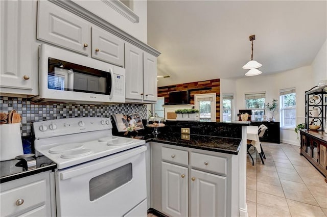 2220 Lily Valley Dr, Lawrenceville, GA 30045 - kitchen featuring white appliances, a peninsula, dark countertops, white cabinets, and tasteful backsplash