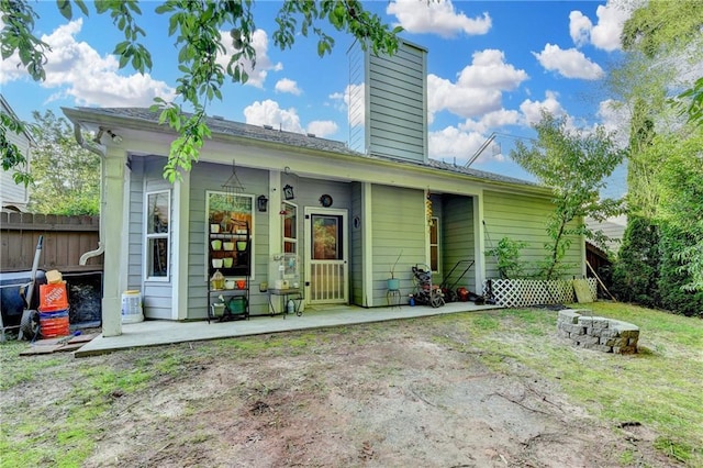 2220 Lily Valley Dr, Lawrenceville, GA 30045 - rear view of house with a chimney and an outdoor fire pit