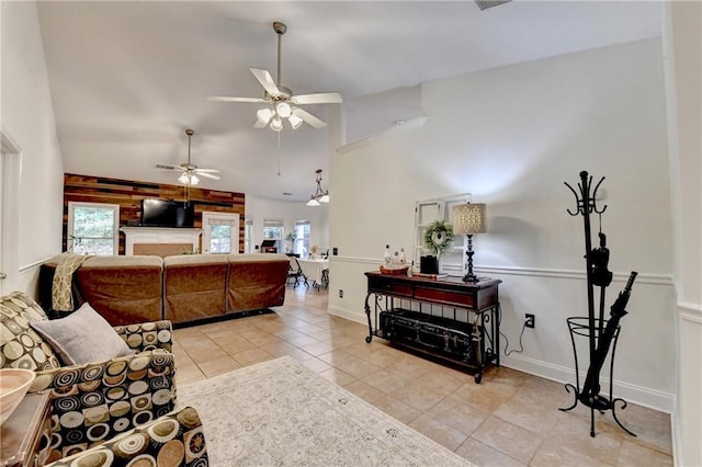 2220 Lily Valley Dr, Lawrenceville, GA 30045 - living area with healthy amount of natural light, light tile patterned floors, a ceiling fan, and high vaulted ceiling