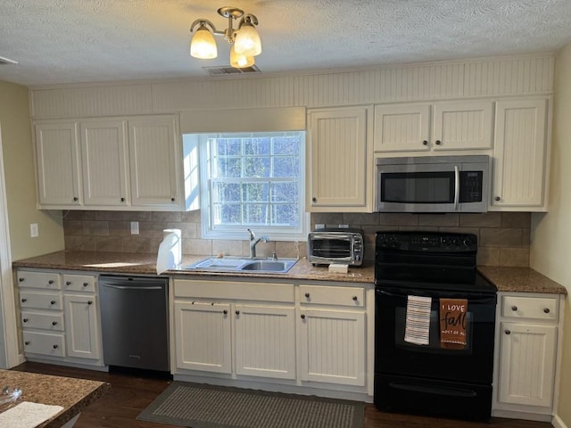 kitchen featuring dishwashing machine, sink, white cabinetry, backsplash, and black / electric stove