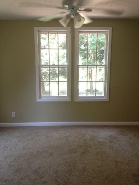 unfurnished room with carpet floors and ceiling fan