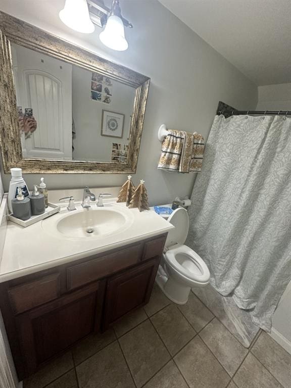 bathroom with tile patterned floors, vanity, and toilet