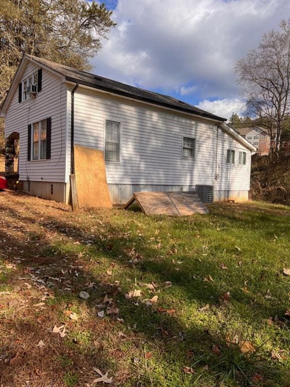 view of side of home featuring a yard