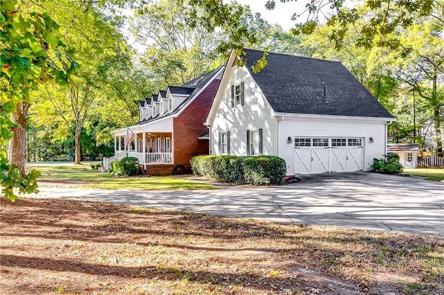 view of front of house with covered porch and a garage