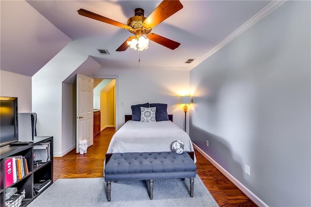 bedroom with ceiling fan, ornamental molding, and dark hardwood / wood-style flooring