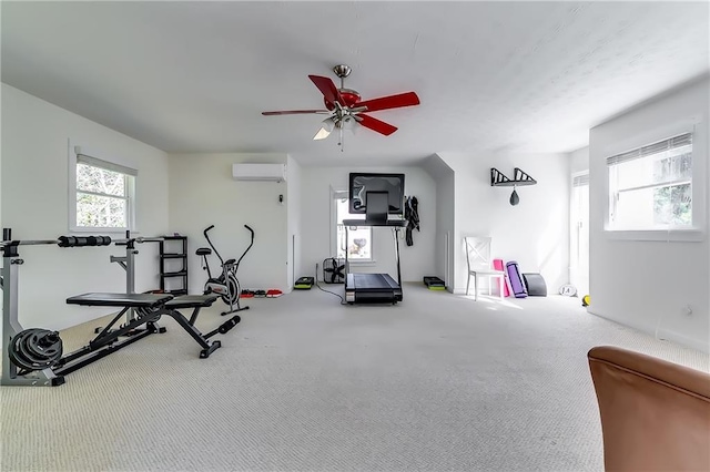 exercise room featuring carpet, a wall mounted air conditioner, and ceiling fan