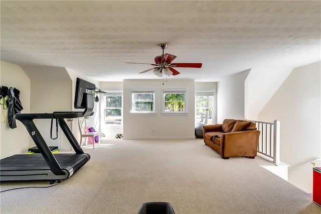 exercise area featuring light colored carpet and ceiling fan