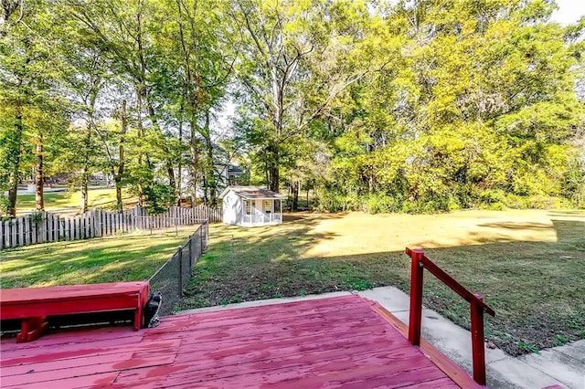 exterior space featuring a wooden deck and a storage shed