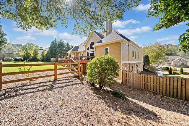 view of property exterior featuring a wooden deck