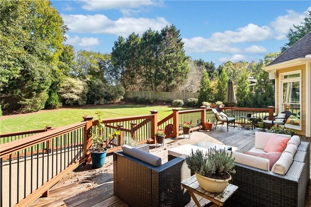 deck featuring outdoor lounge area and a yard