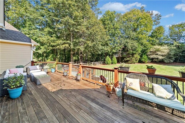 wooden deck with a lawn and an outdoor hangout area