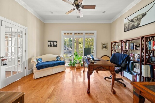 office space featuring french doors, light wood-type flooring, ceiling fan, and crown molding