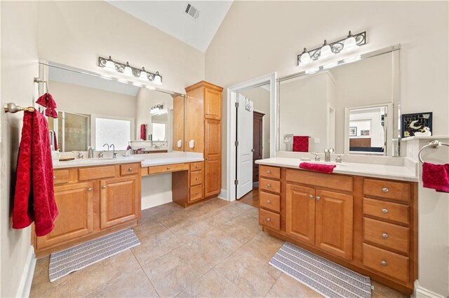 bathroom with tile patterned floors, vanity, lofted ceiling, and a shower with door