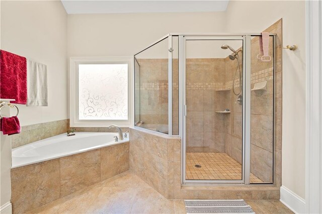 bathroom with tile patterned flooring and independent shower and bath