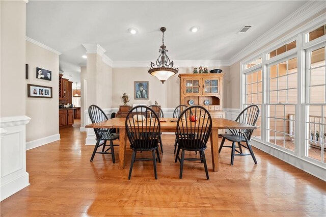 dining room featuring light hardwood / wood-style floors and ornamental molding