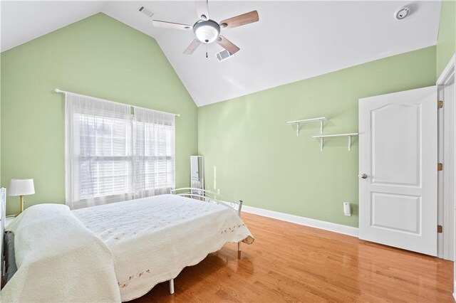 bedroom featuring hardwood / wood-style floors, high vaulted ceiling, and ceiling fan