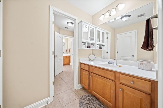 bathroom with tile patterned flooring and vanity