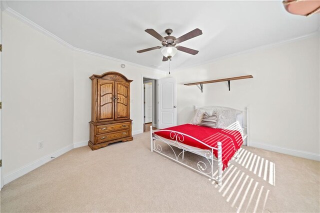 carpeted bedroom with ceiling fan and crown molding