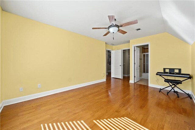 interior space featuring hardwood / wood-style flooring, ceiling fan, and vaulted ceiling