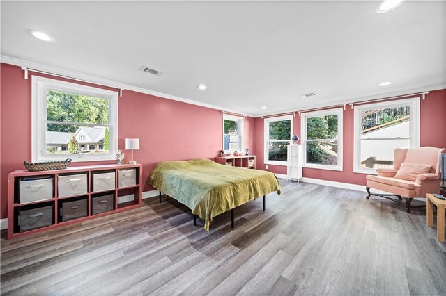 bedroom featuring hardwood / wood-style floors and ornamental molding