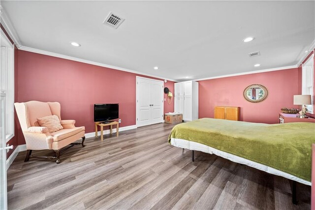 bedroom with wood-type flooring and ornamental molding