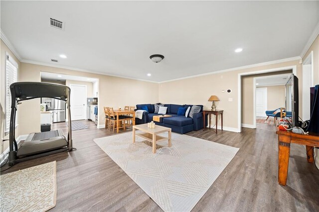 living room featuring hardwood / wood-style flooring and ornamental molding