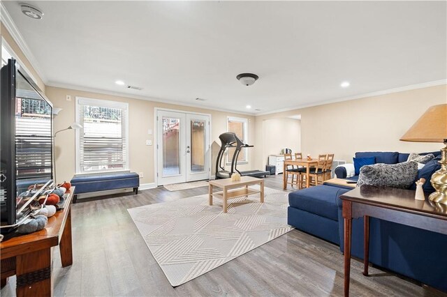 interior space with french doors, crown molding, and wood-type flooring