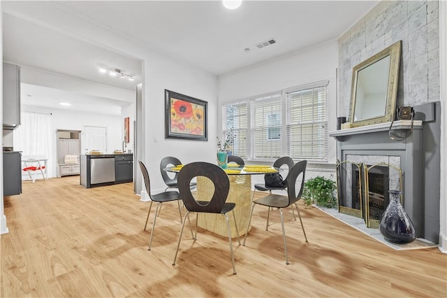 1463 Metropolitan Pkwy SW, Atlanta, GA 30310 - dining room featuring light wood-style flooring and a large fireplace