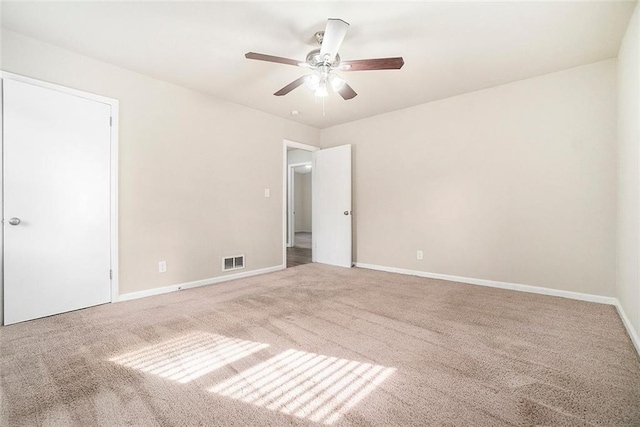 unfurnished room with ceiling fan and carpet floors