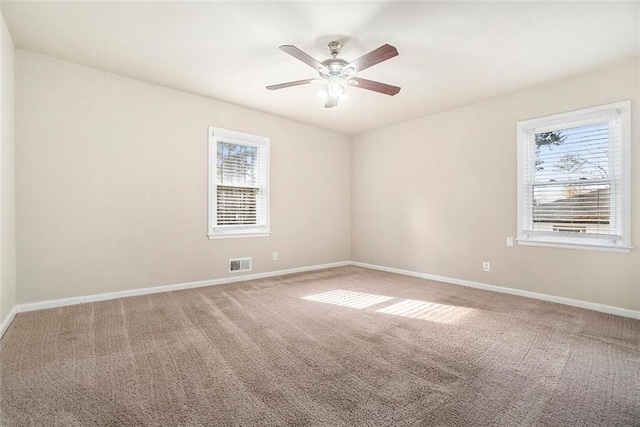 unfurnished room with ceiling fan and carpet flooring